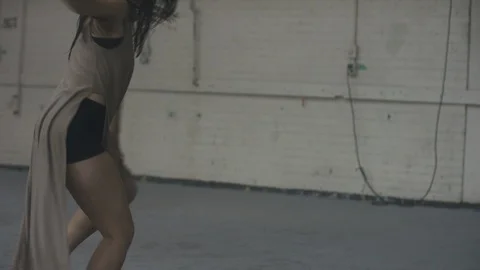 Dancer dancing passionately with lots of energy in industrial warehouse 스톡 동영상 104481915