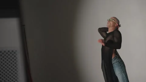 Dancer dancing in studio with artificial lighting. Modern dancer on dark gray Stock Footage 294999074