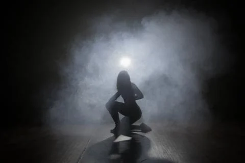 Dancer in the dark and smoke Stock Photos