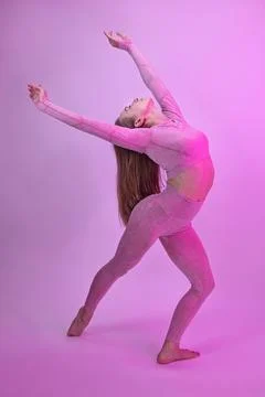 A dancer demonstrates dance warm-up movements in the style of modern dance on a Stock Photos