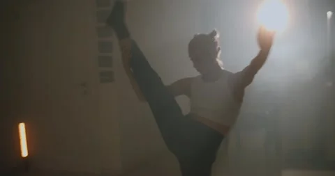 Dancer doing freestyle contemporary dance routine while practicing in studio Stock Footage 229487941