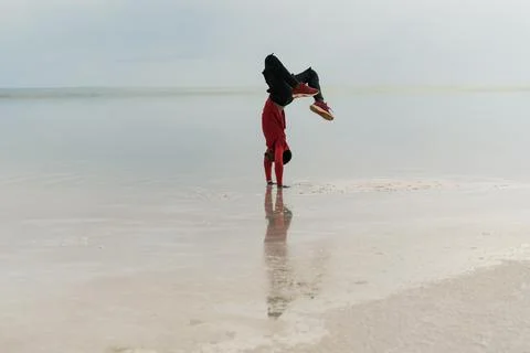 Dancer doing handstand on the beach Stock Photos