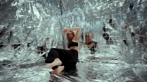 Dancer Expressing Emotions through Contemporary Choreography on Foil Floor Stock Footage 306990507