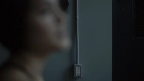 Dancer on the floor warming up and stretching in dark moody dance studio 스톡 동영상 104273381