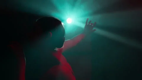 Dancer girl gracefully moves in modern dance in light rays, slow motion Stock Footage 242912079