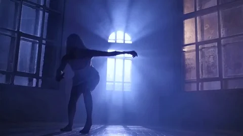 Dancer girl in white dress dancing contemporary, silhouette. Slow motion Stock Footage