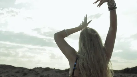Dancer gracefully moves her arms in beautiful choreography against cloudy s.. Stock Footage 293916660