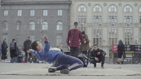 The dancer guy is dancing breakdance on the street. Slow motion. Stock Footage