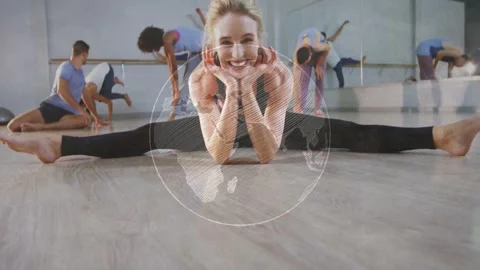 Dancer holding straddle split in dance studio, globe graphic fading and Stock Footage 332592038