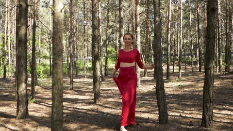 Dancer improvisation. Skill ballerina woman in red dress dancing in forest. Slow Stock Footage 109683074
