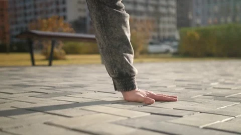 The dancer jumps on one hand and freezes in the air in one position. Stock Footage 164914887