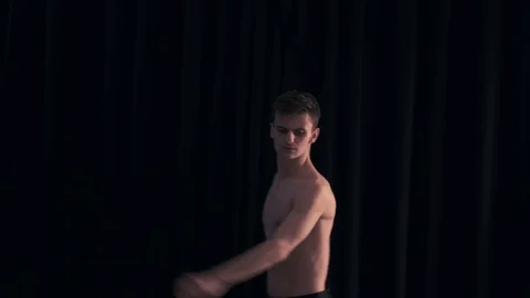 Dancer makes circular movements with his body in the dark Video stock 77381474