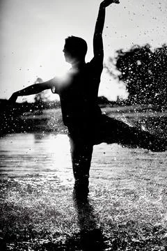 Dancer man with his back wet in a lake with a red shirt. Stock Photos