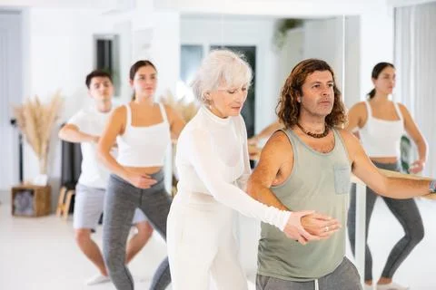 Dancer man learn ballet elements with choreographer during group training at Stock Photos
