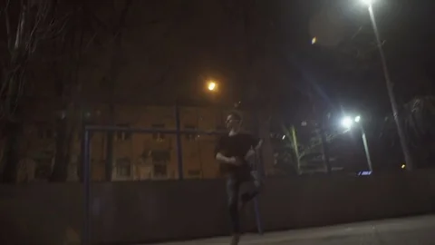 Dancer man is spinning at night on the street Stock Footage 77380853