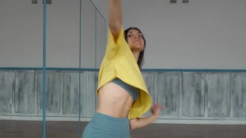 A dancer moves fluidly with expressive arm gestures, highlighting improvisation. Stock Footage 287099571