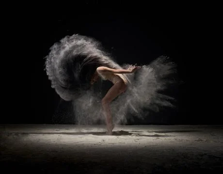 Dancer moving in cloud of white dust at studio Contemporary art - full len... Stock Photos