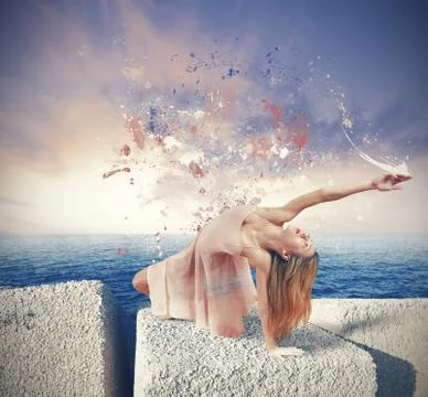 Dancer paints the sky suring sunset Stock Photos