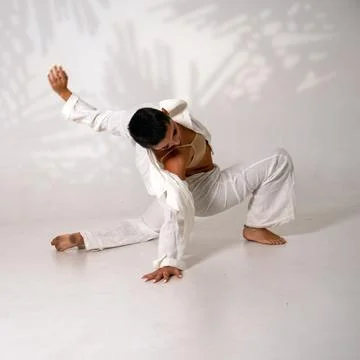 Dancer performing contemporary movement on white background Stock Photos
