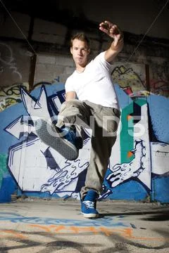 Dancer performing dance move in urban scene Stock Photos