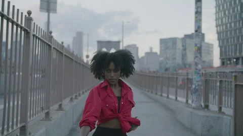 Dancer performing energetic routines on sidewalk in Brooklyn during sunset Stock Footage 312595326