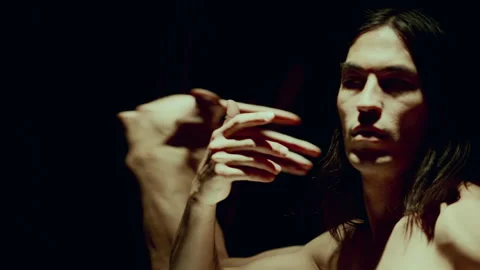 Dancer Performing Enigmatic Moves in front of Distorting Mirror in Studio Stock Footage 289853367