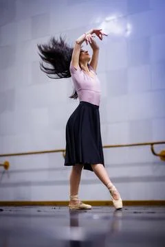 Dancer performs ballet in studio with focus on technique and movement during Stock Photos