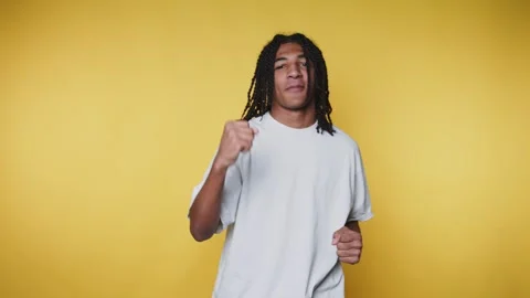 Dancer performs different moves in front of a bright yellow background whil.. 스톡 동영상 328249554