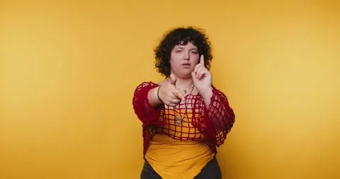 Dancer performs expressive hand movements in front of a bright yellow backg.. Vídeos de archivo 328248022