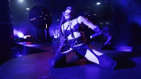 Dancer performs a seductive dance on stage with concert lighting, Video stock 273326321