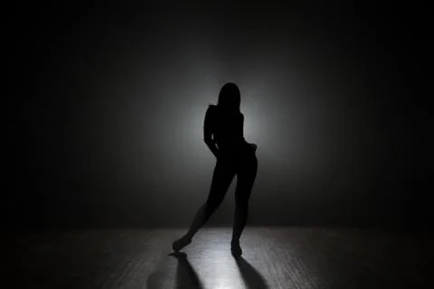 Dancer posing backlit. Stock Photos