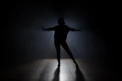 Dancer posing in the dark and smoke Stock Photos