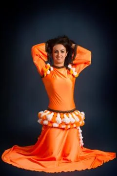 Dancer posing in traditional orange costume Stock Photos