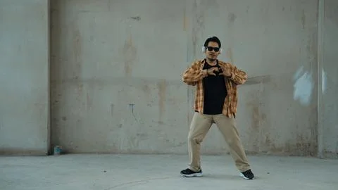 Dancer practice street dance while listen music at cement background. Endeavor. 写真素材