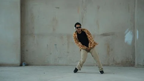 Dancer practice street dance while listen music at cement background. Hiphop. 写真素材