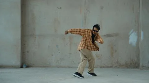 Dancer practice street dance while listen music at cement background. Hiphop. 写真素材
