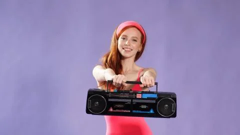Dancer preparing for an aerobics competition is holding a portable tape recorder Stock Photos