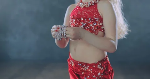 Dancer puts bracelets on her hands, stones sparkle. Smooth movements with his 스톡 동영상 109498243