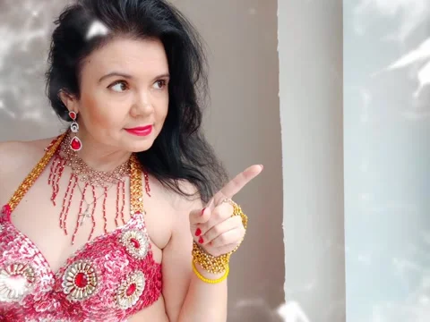 A dancer in a red suit is dancing an oriental dance on a white background. A Stock Footage 270200196