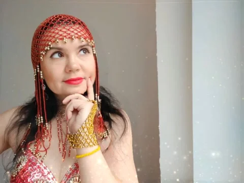 A dancer in a red suit is dancing an oriental dance on a white background. A Stock Footage 272850408