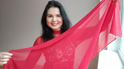 A dancer in a red suit is dancing with a red shawl an oriental dance on a white Stock Photos