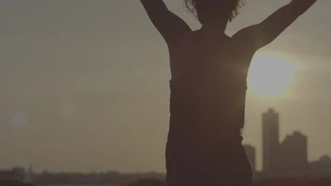 Dancer showcasing dynamic stretching and balance against sunset skyline Stock Footage 312622583