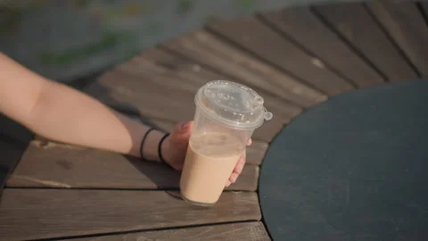 Dancer sips coffee, Casual urban setting with woman enjoying beverage in Stock Footage 327660731