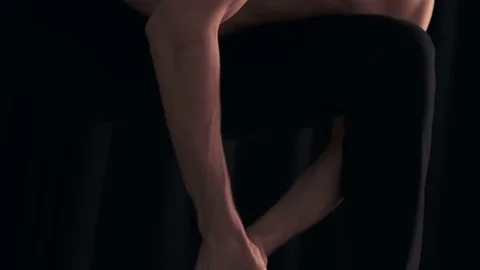 Dancer sits and performs movements with his hands Stock Footage 77381631