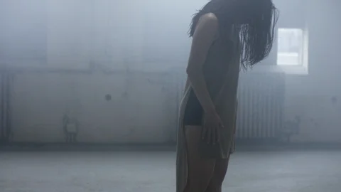 Dancer slides her hands along her body, leaning back, slowly beginning to dance 스톡 동영상 104483886