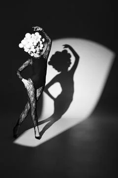 Dancer with spheres head shadow on wall Stock Photos