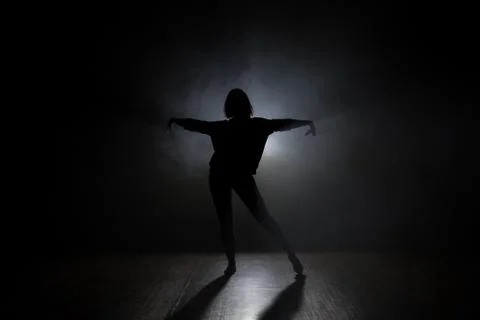 Dancer in studio with smooke on a dark background Stock Photos