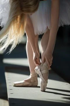 Dancer tying pointe shoes Stock-Fotos