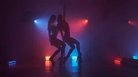 Dancers in dark studio with pole at blue and red smoke. Beautiful dancing girls Stock Footage 124196348