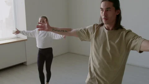 Dancers Doing Forward and Lateral Leg Swings during Warmup in Studio Stock Footage 282526238
